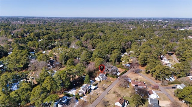 birds eye view of property featuring a view of trees