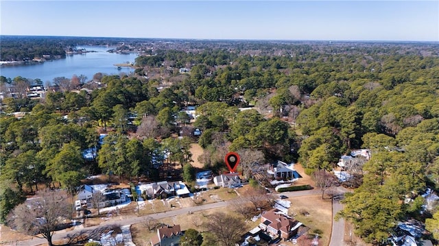 birds eye view of property featuring a water view and a view of trees