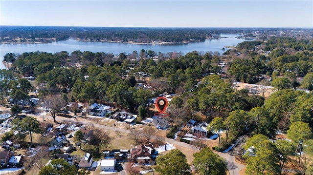 birds eye view of property featuring a water view and a view of trees