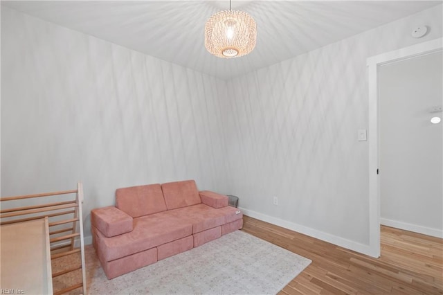 living area with baseboards and wood finished floors