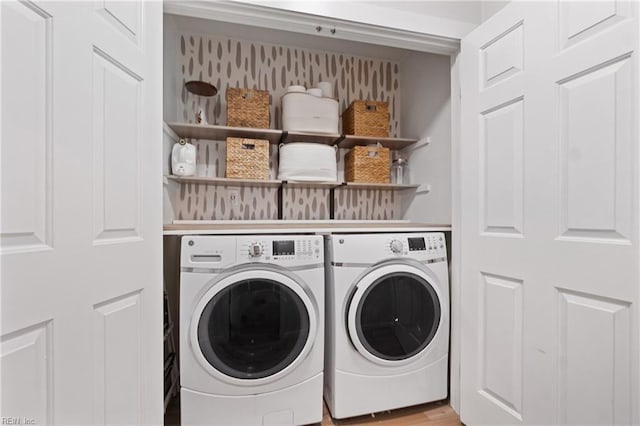 laundry room with laundry area, independent washer and dryer, and light wood finished floors