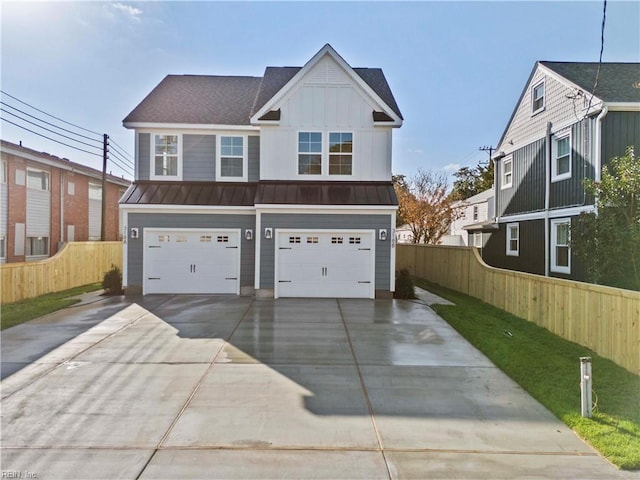 view of front facade featuring an attached garage, a standing seam roof, fence, and board and batten siding