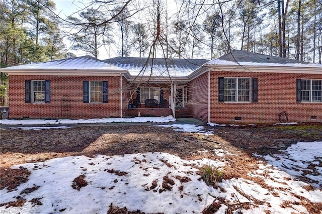 view of front facade with brick siding and crawl space