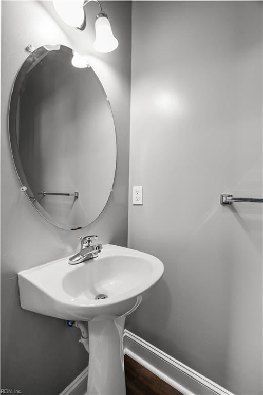 bathroom with baseboards and wood finished floors