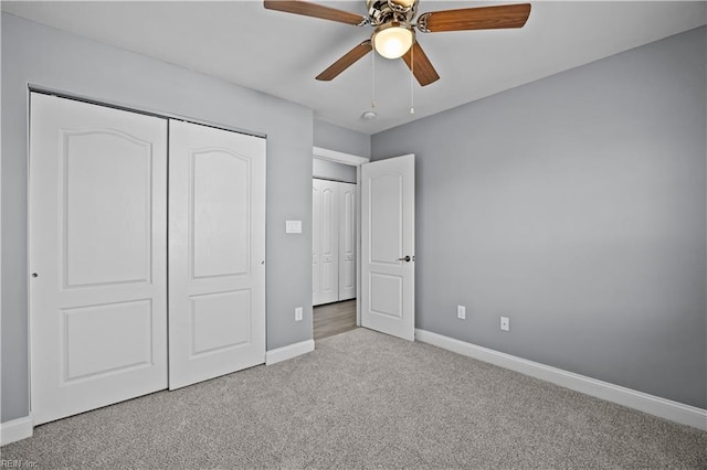 unfurnished bedroom with baseboards, a closet, a ceiling fan, and light colored carpet