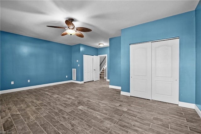 unfurnished bedroom featuring ceiling fan, wood finished floors, and baseboards