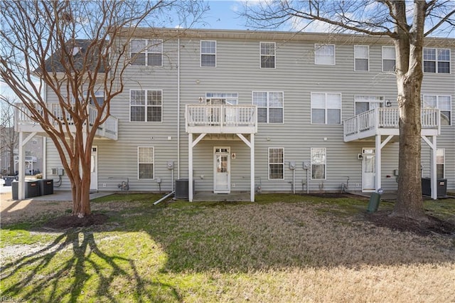 rear view of property featuring a yard