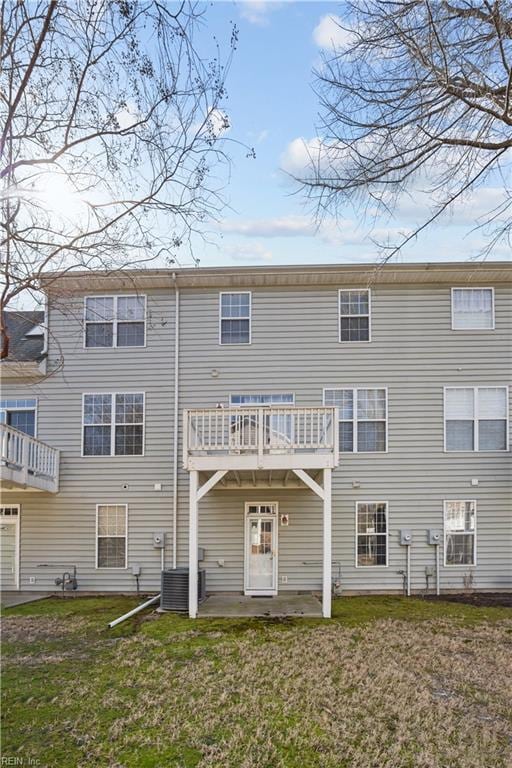 back of house with a yard and central AC