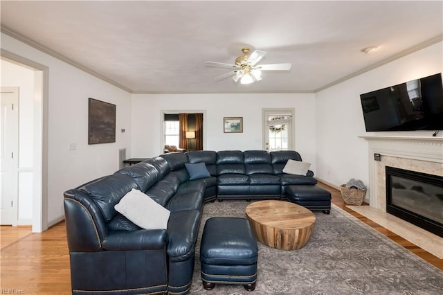 living area with plenty of natural light, crown molding, and wood finished floors