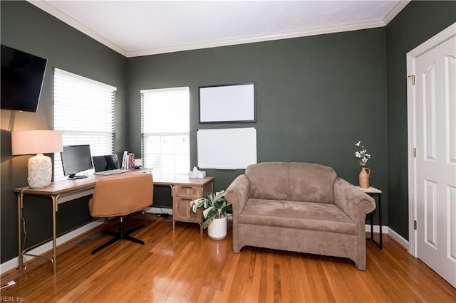 office with baseboards, light wood finished floors, and crown molding