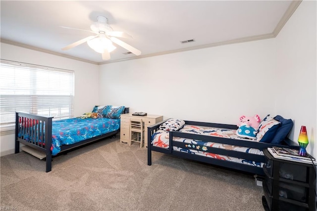 bedroom with ornamental molding, visible vents, ceiling fan, and carpet flooring