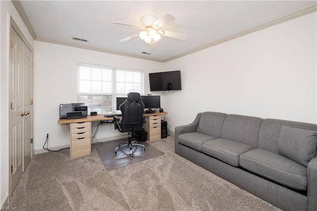 carpeted office featuring ceiling fan, baseboards, visible vents, and crown molding