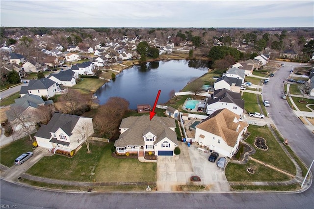 birds eye view of property featuring a water view and a residential view