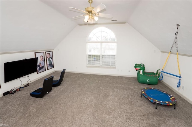 interior space featuring lofted ceiling, ceiling fan, baseboards, and carpet flooring