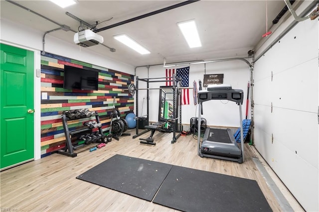 exercise area featuring a garage and wood finished floors