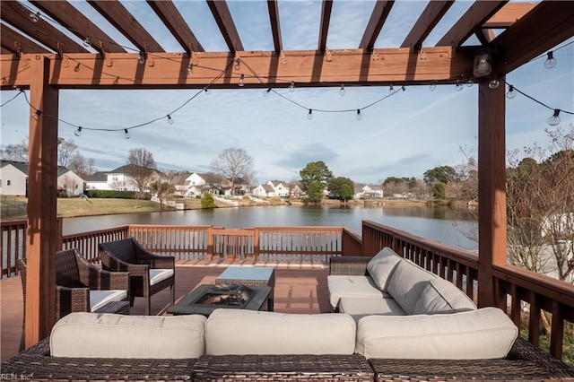 wooden deck with an outdoor living space with a fire pit, a water view, and a pergola