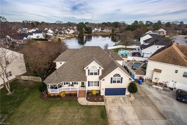 bird's eye view with a residential view and a water view