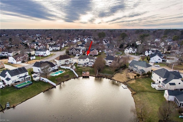 birds eye view of property featuring a water view and a residential view