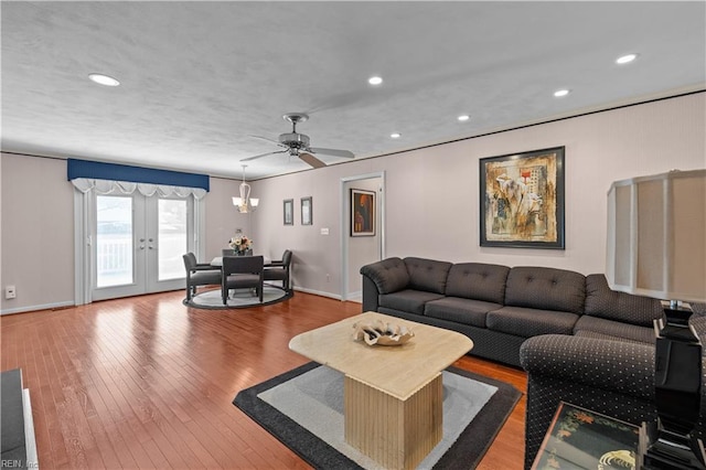 living area with hardwood / wood-style flooring, recessed lighting, baseboards, and french doors