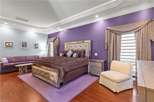 bedroom with hardwood / wood-style flooring, visible vents, crown molding, and recessed lighting