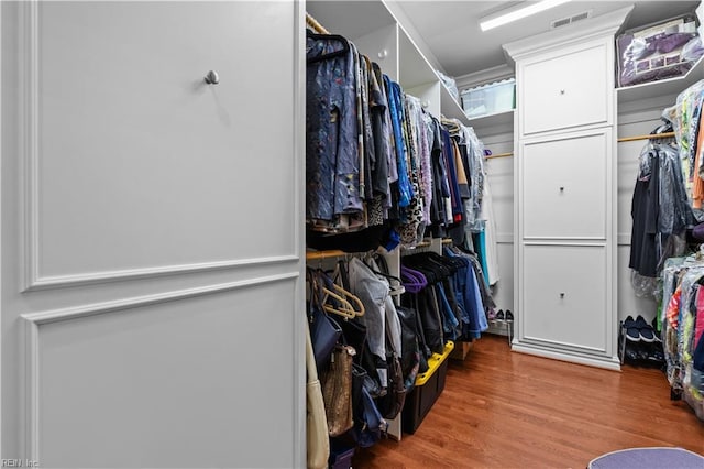 spacious closet featuring visible vents and wood finished floors