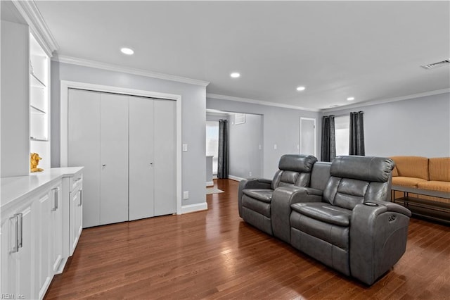 interior space with visible vents, ornamental molding, and dark wood-style flooring