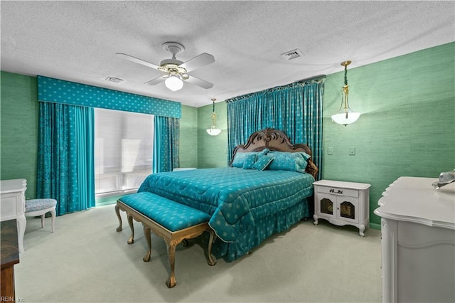 bedroom with wallpapered walls, ceiling fan, visible vents, and carpet flooring