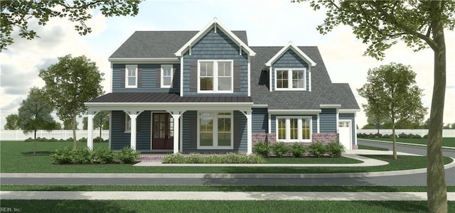 view of front facade featuring metal roof, brick siding, fence, a front lawn, and a standing seam roof