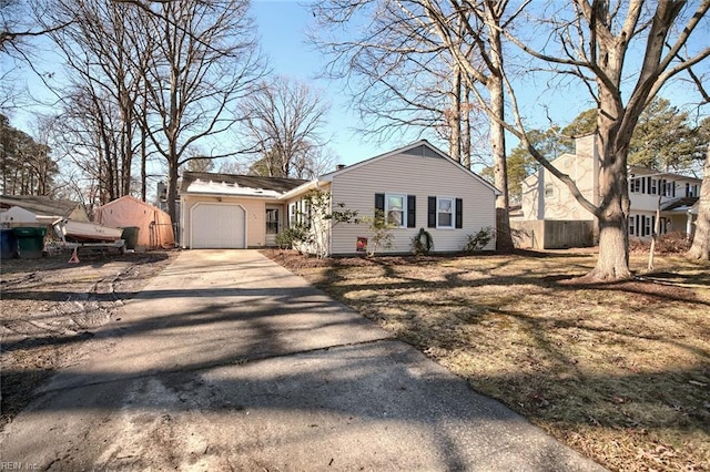 view of front of property featuring a garage, driveway, and fence