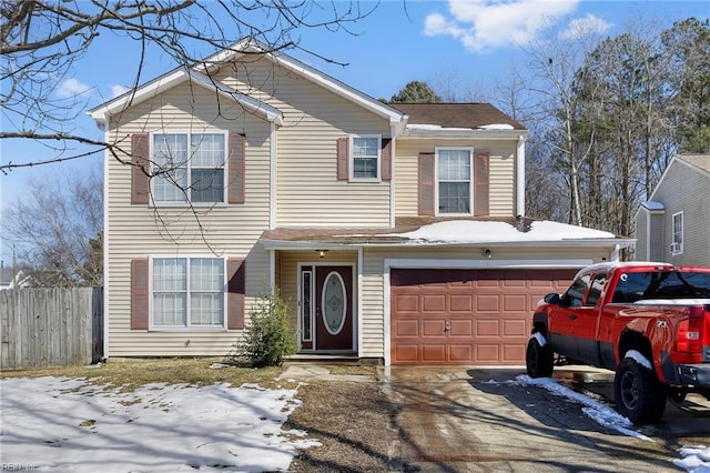 view of front of home featuring a garage, fence, and driveway