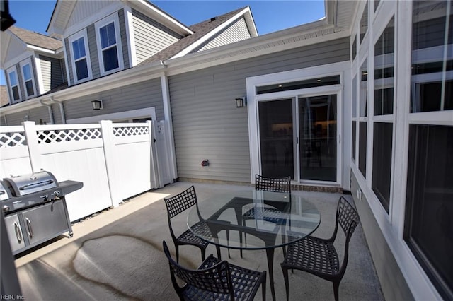 view of patio / terrace featuring outdoor dining area, a grill, and fence