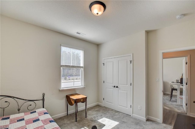 bedroom with visible vents and baseboards