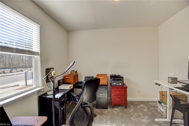 office area featuring baseboards and light colored carpet