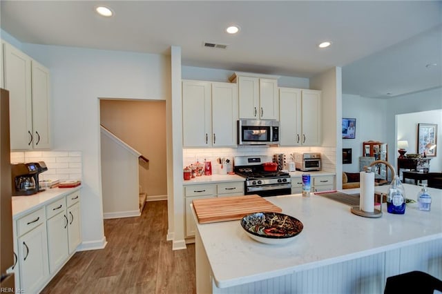 kitchen featuring visible vents, appliances with stainless steel finishes, and light countertops