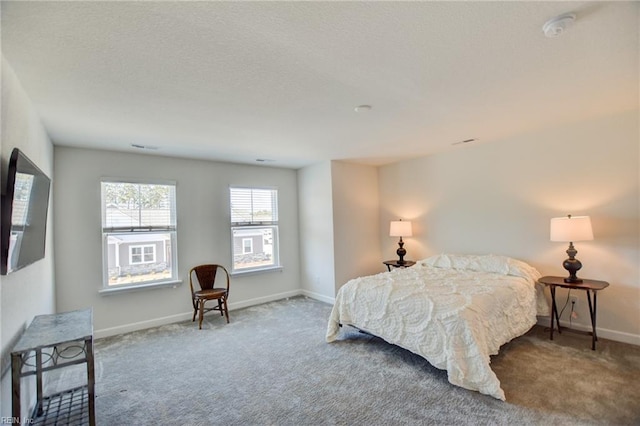 carpeted bedroom featuring baseboards