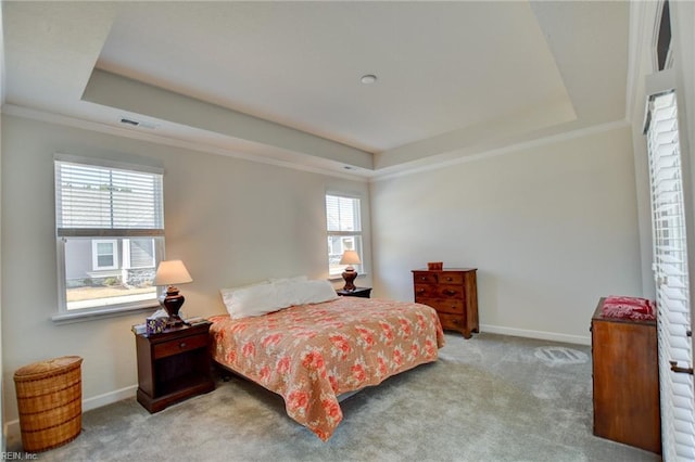 bedroom featuring carpet, visible vents, a tray ceiling, and baseboards