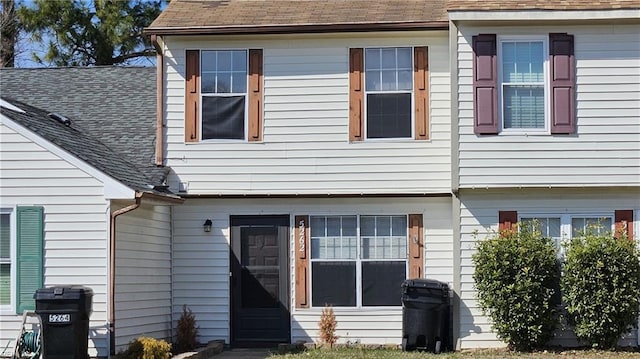 back of property featuring a shingled roof