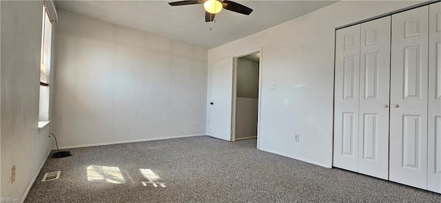 unfurnished bedroom with carpet floors, a closet, visible vents, a ceiling fan, and baseboards