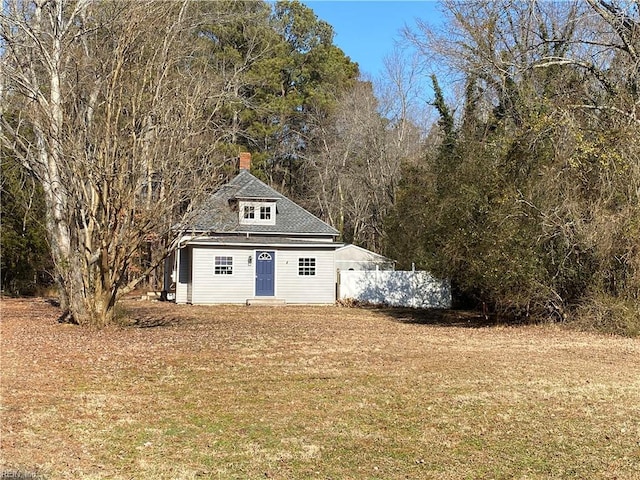 view of outbuilding featuring fence