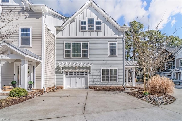 view of front of house featuring a garage, driveway, and board and batten siding