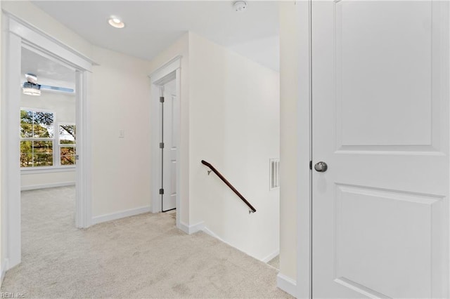 hall featuring recessed lighting, baseboards, carpet flooring, and an upstairs landing