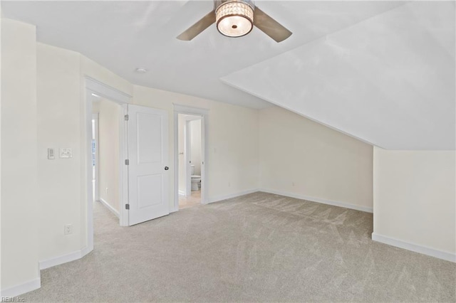 additional living space with lofted ceiling, carpet floors, and baseboards