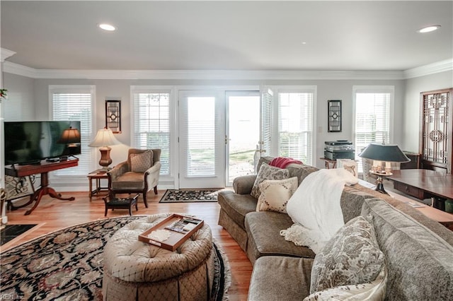 living room featuring recessed lighting, light wood-style flooring, and crown molding