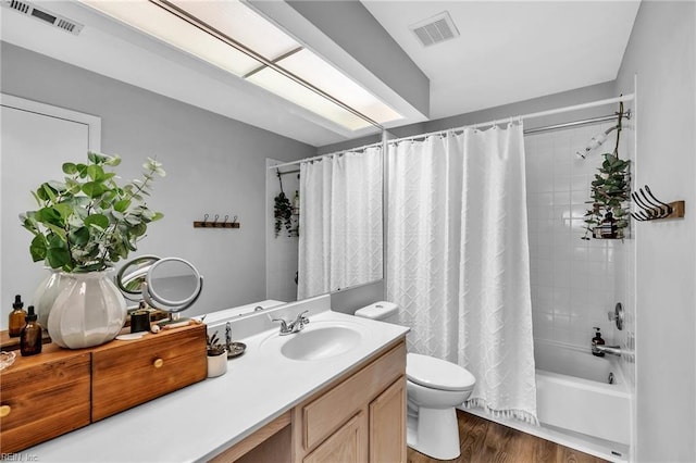 full bathroom with shower / bath combination with curtain, visible vents, toilet, and wood finished floors