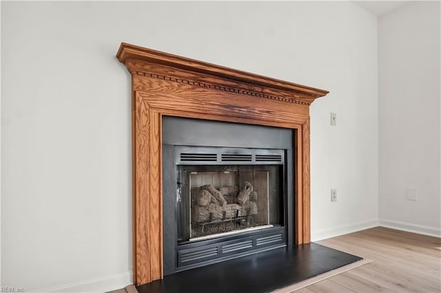 details featuring baseboards and wood finished floors