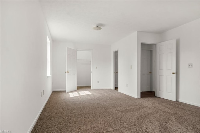 unfurnished bedroom featuring carpet flooring and baseboards