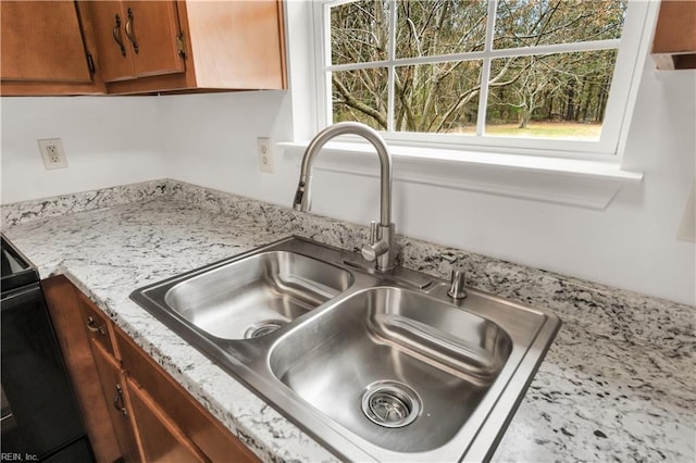 interior details with brown cabinetry and a sink