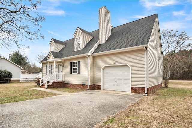 new england style home featuring driveway, a garage, a shingled roof, crawl space, and a front yard