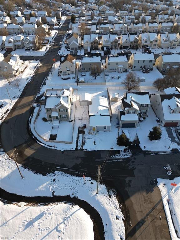 snowy aerial view featuring a residential view