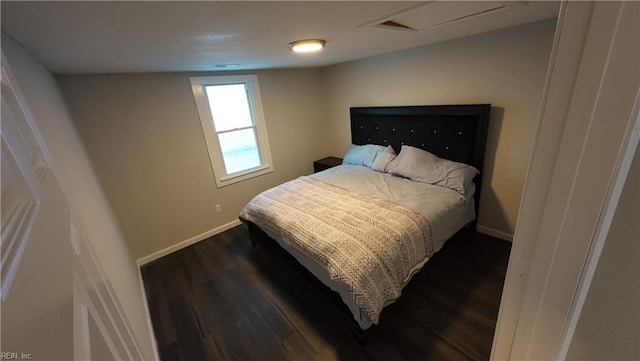 bedroom featuring dark wood-style floors and baseboards